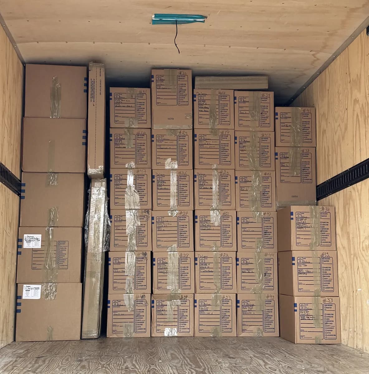 Loaded restoration truck showing rows of labeled, inventoried contents cartons