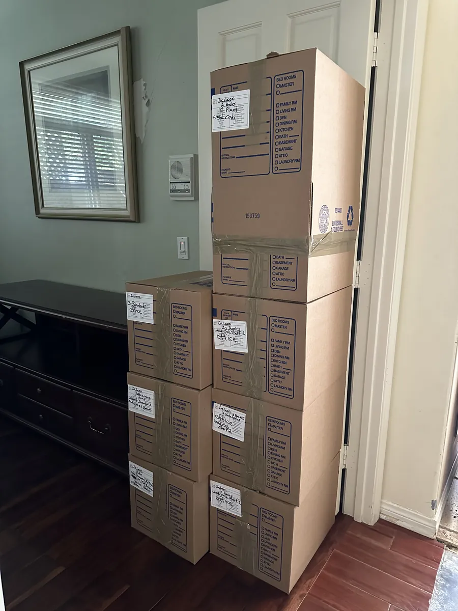 Organized stack of labeled contents boxes packed and documented during a pack-out