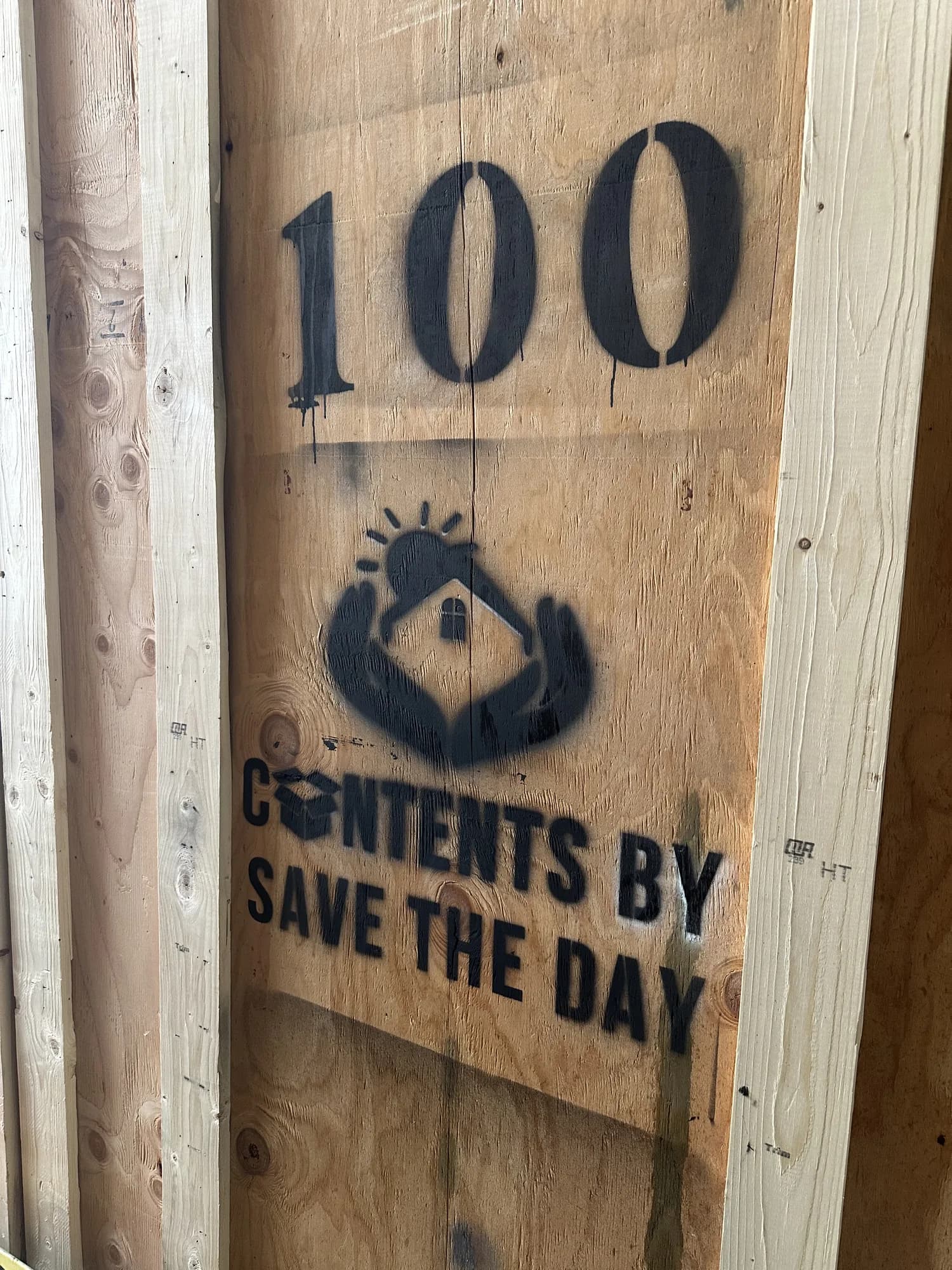 Contents by Save The Day logo stenciled on a numbered wood storage vault