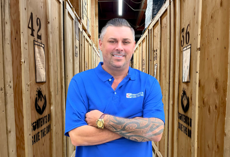 Owner of Contents by Save The Day standing in front of storage pods, showcasing restoration partners. Contact Us Today! Check Out our Blog too!